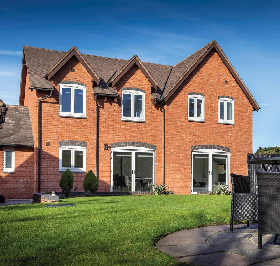 Brick house with white flush casements and French doors – Roundhay Windows And Doors